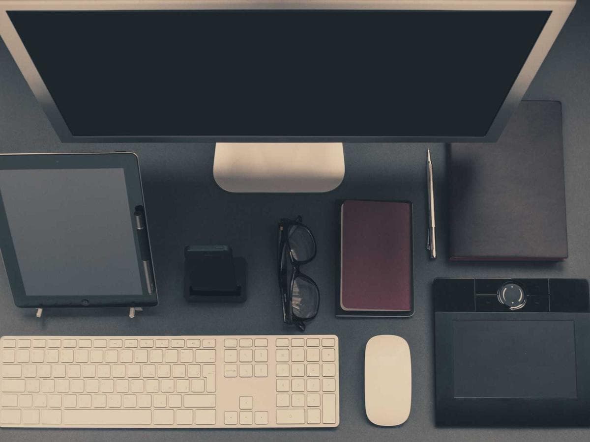 Overhead view of a desk with display, keyboard and input devices